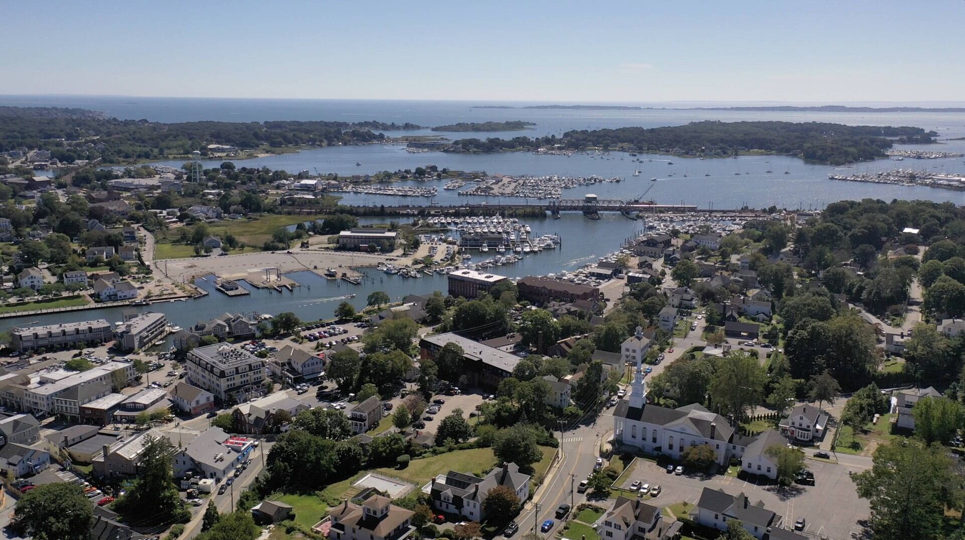 Aerial view of Mystic, Connecticut harbor with drawbridge, sailboats, and marinas